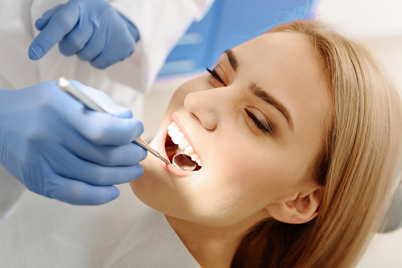 NTI Splints as lady has teeth examined while in the dentist chair